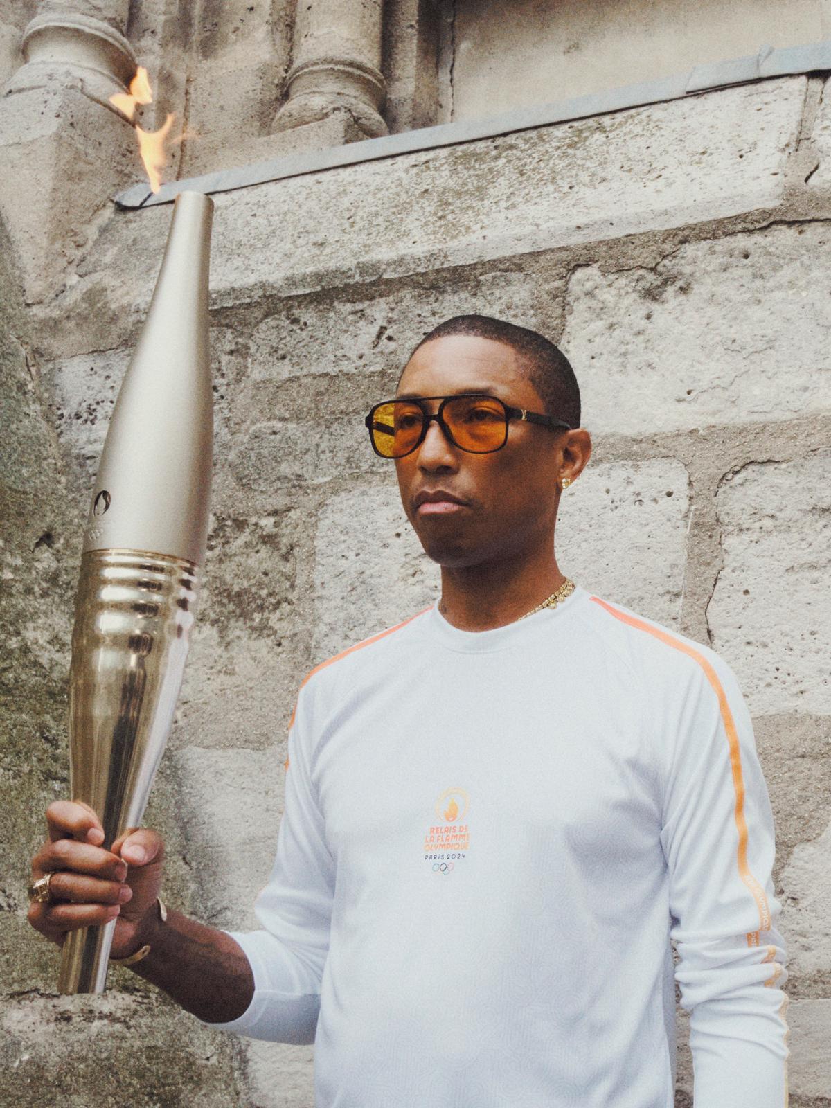Image may contain Pharrell Williams Light Torch Adult Person Accessories Glasses Jewelry Ring and Mortar Shell